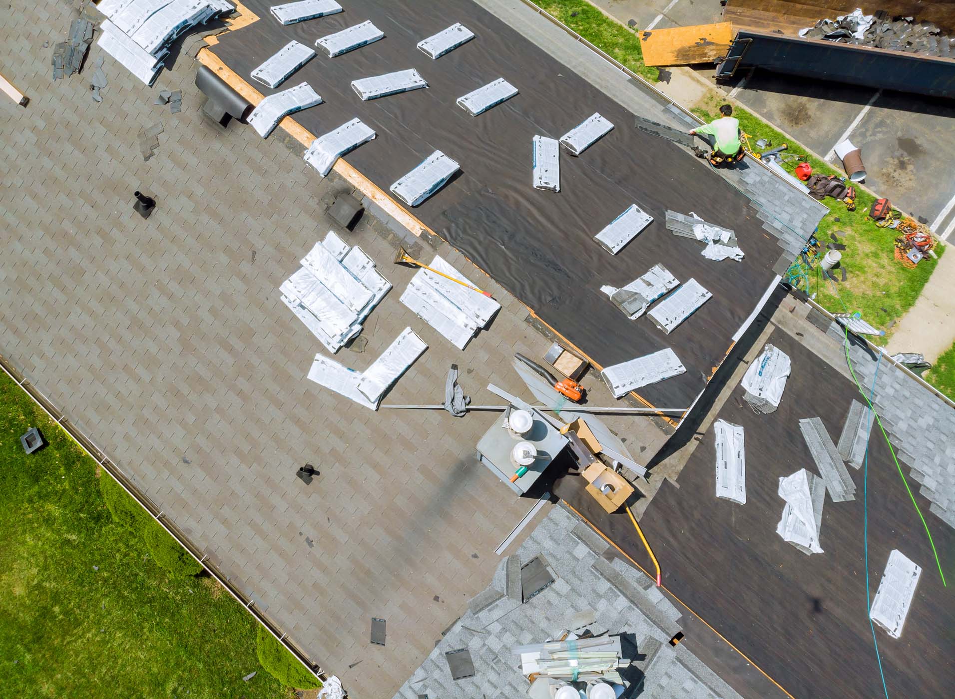 A roofing company works to repair a roof
